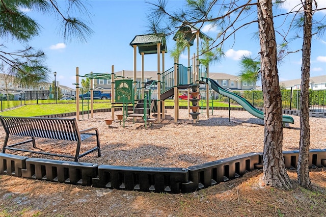 community jungle gym with fence and a residential view