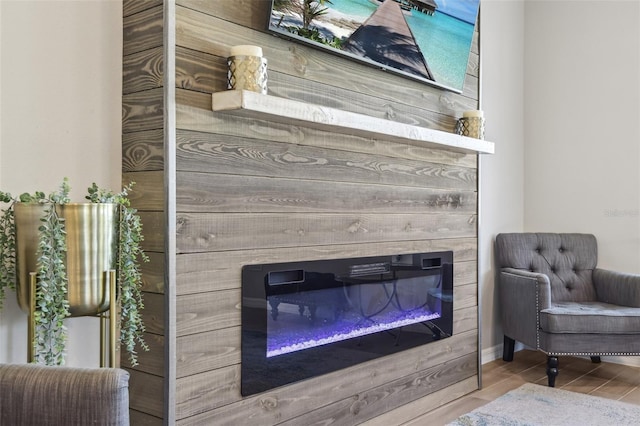 interior details with a glass covered fireplace