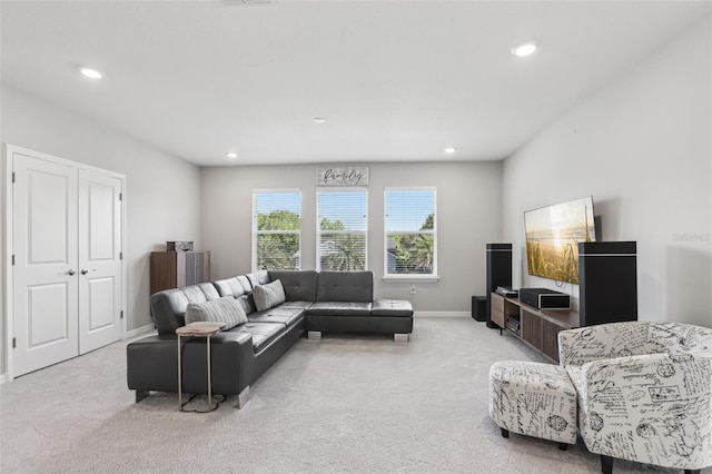 living area with light carpet, recessed lighting, and baseboards