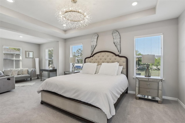 carpeted bedroom with an inviting chandelier, baseboards, a tray ceiling, and multiple windows