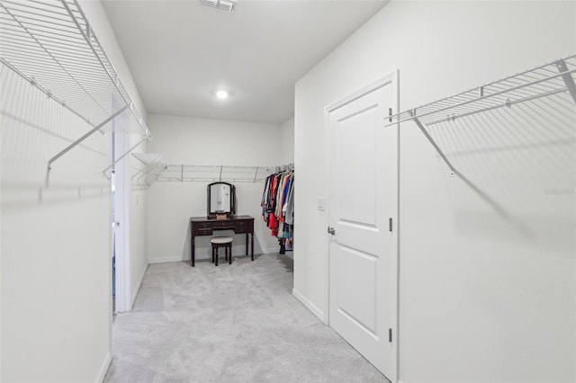 spacious closet featuring light carpet and visible vents