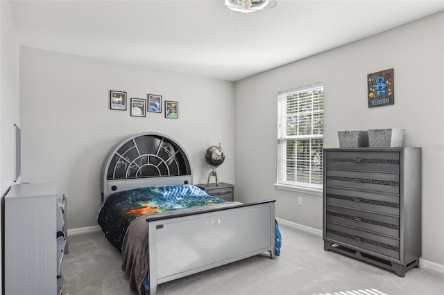 carpeted bedroom featuring baseboards