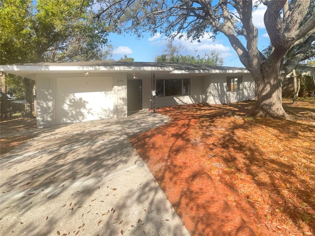 view of front of house with concrete driveway and an attached garage