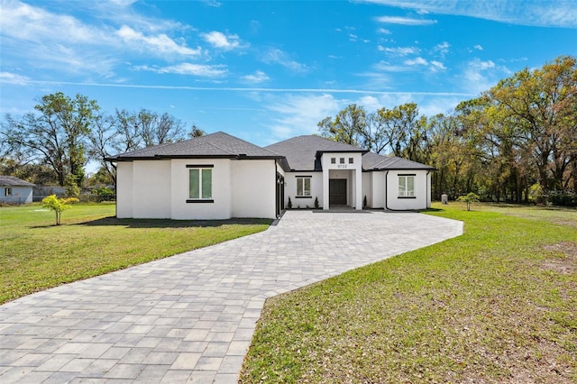 view of front of home with stucco siding and a front yard