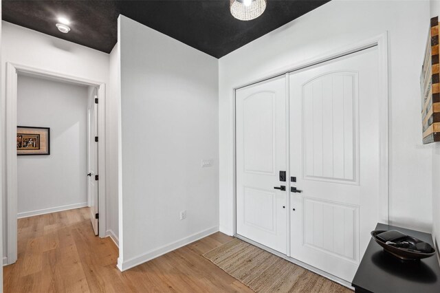 entrance foyer with light wood-style floors and baseboards