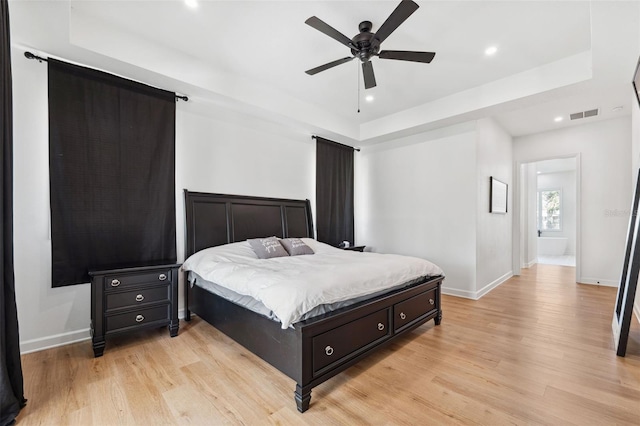 bedroom with baseboards, recessed lighting, visible vents, and light wood-style floors