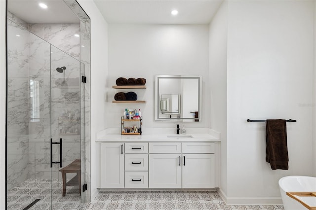 full bathroom featuring a marble finish shower, baseboards, vanity, a freestanding tub, and recessed lighting