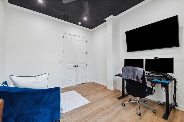 office with ornamental molding, visible vents, baseboards, and wood finished floors