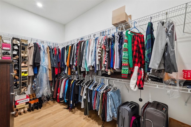 walk in closet with wood finished floors