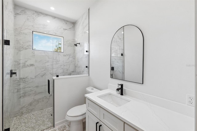 bathroom with vanity, a marble finish shower, toilet, and recessed lighting