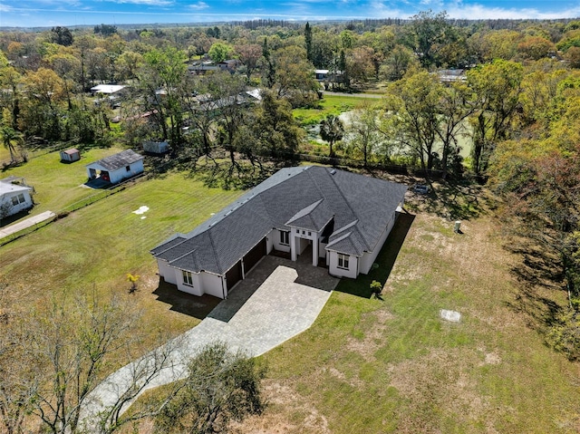 birds eye view of property with a wooded view