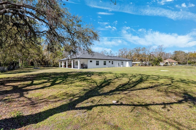 back of property with a lawn