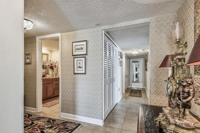 634 Edgewater Dr Unit 744, Dunedin, FL 34698 - hallway with light tile patterned floors, a textured ceiling, and wallpapered walls