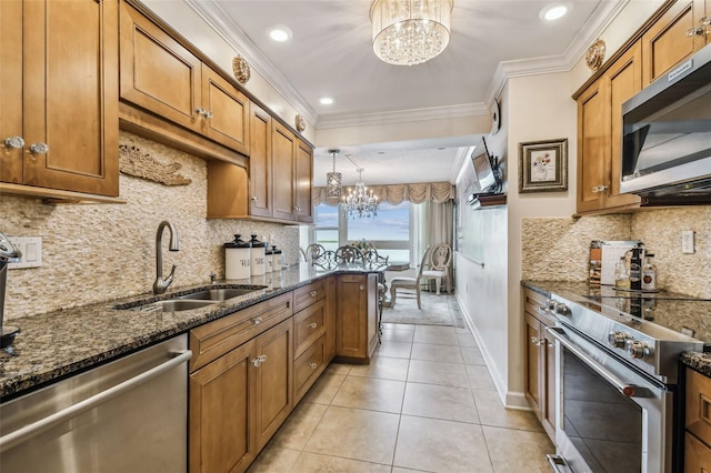 634 Edgewater Dr Unit 744, Dunedin, FL 34698 - kitchen featuring a chandelier, appliances with stainless steel finishes, brown cabinets, crown molding, and dark stone countertops
