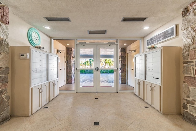 634 Edgewater Dr Unit 744, Dunedin, FL 34698 - surrounding community featuring french doors, a textured ceiling, and mail area