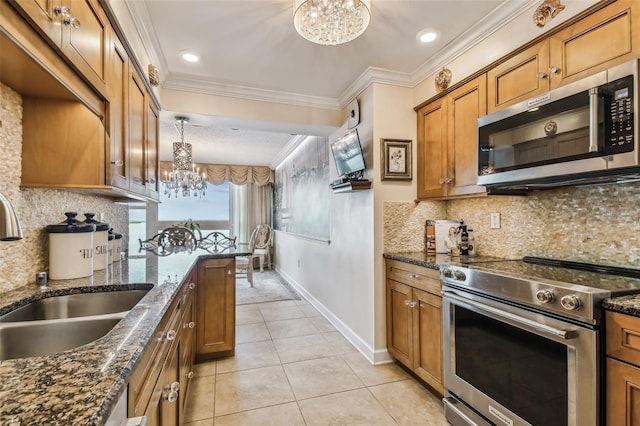 634 Edgewater Dr Unit 744, Dunedin, FL 34698 - kitchen with stainless steel appliances, a chandelier, brown cabinetry, ornamental molding, and light tile patterned floors