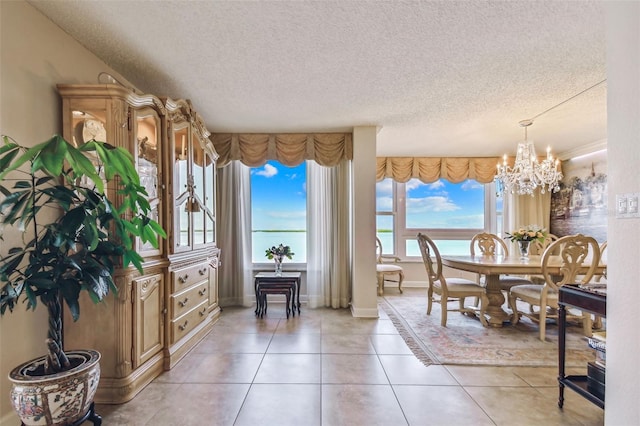 634 Edgewater Dr Unit 744, Dunedin, FL 34698 - dining area with a textured ceiling, a chandelier, and light tile patterned floors