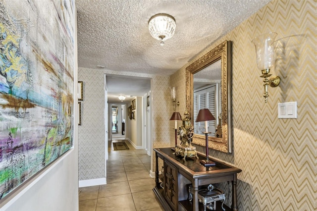 634 Edgewater Dr Unit 744, Dunedin, FL 34698 - hall with wallpapered walls, a textured ceiling, and tile patterned flooring