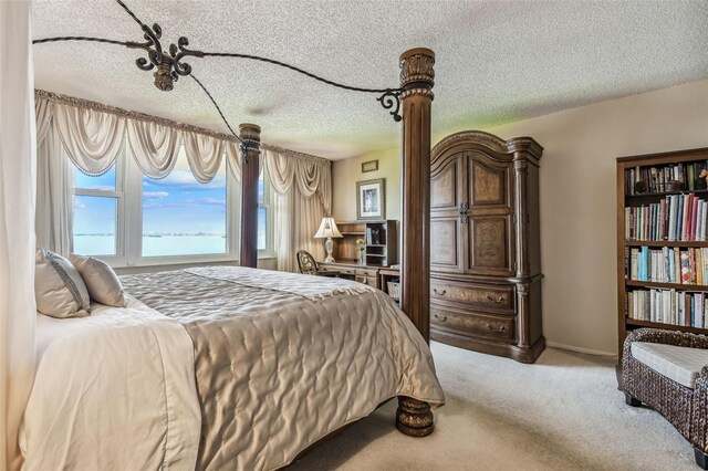634 Edgewater Dr Unit 744, Dunedin, FL 34698 - bedroom with a textured ceiling and carpet flooring