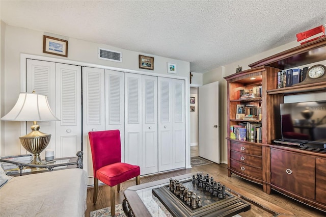 634 Edgewater Dr Unit 744, Dunedin, FL 34698 - living area featuring wood finished floors and a textured ceiling