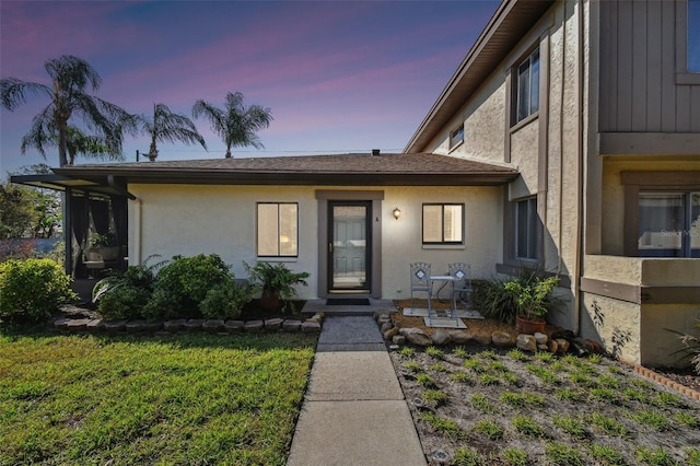 view of front of home featuring a front lawn and stucco siding