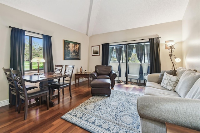 living area featuring baseboards, vaulted ceiling, and wood finished floors