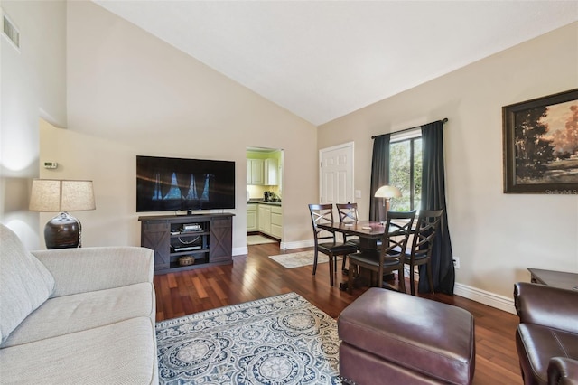 living room with lofted ceiling, baseboards, and dark wood finished floors