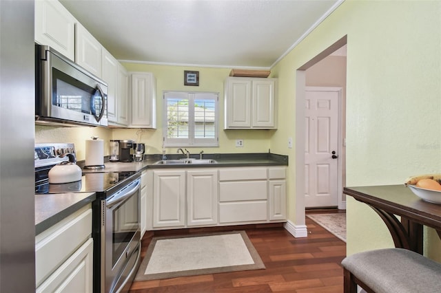 kitchen with white cabinetry, appliances with stainless steel finishes, dark wood-type flooring, and a sink