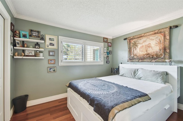 bedroom with ornamental molding, a textured ceiling, baseboards, and wood finished floors