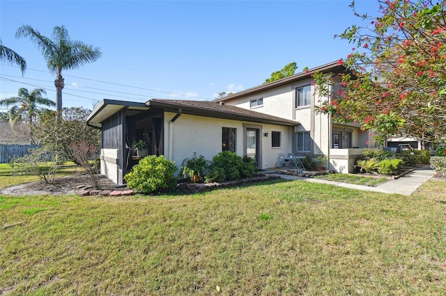 view of front of property with a front yard and stucco siding