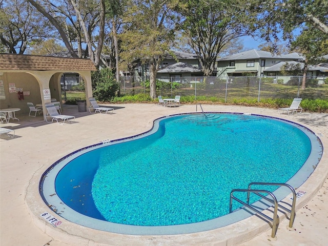 pool featuring fence and a patio