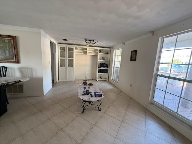 unfurnished living room with light tile patterned floors and visible vents