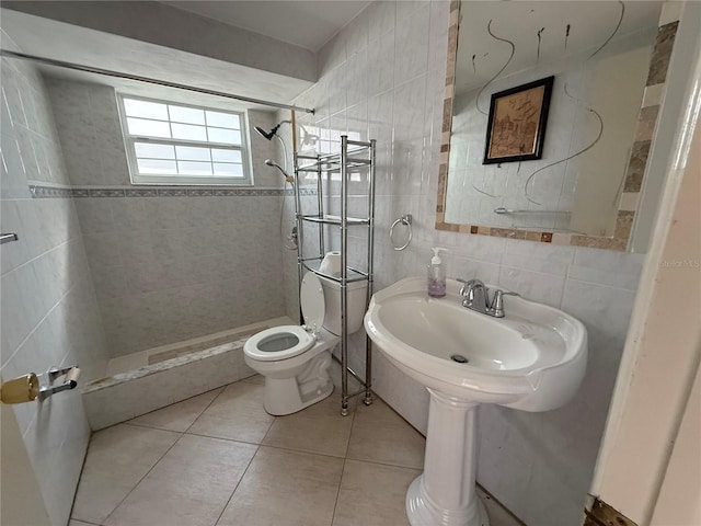 full bath with toilet, a stall shower, backsplash, tile walls, and tile patterned flooring