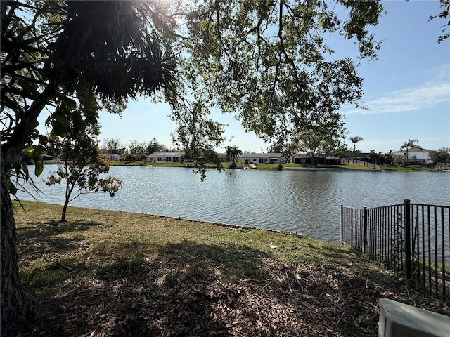 property view of water featuring fence