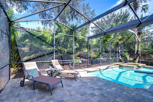 view of pool with a lanai, a patio area, and a pool with connected hot tub