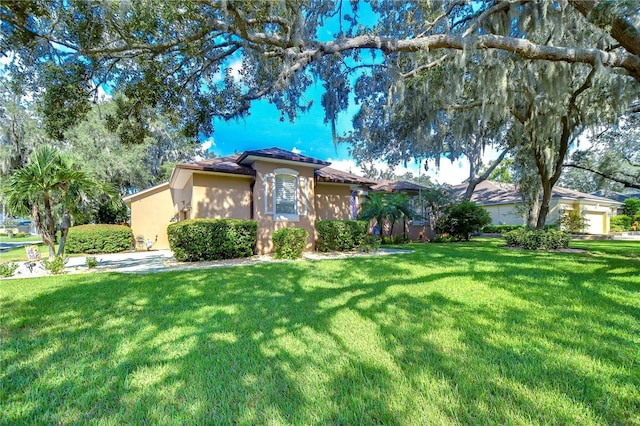 view of front of property with a front yard and stucco siding