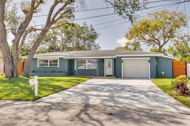 ranch-style house featuring fence, a front yard, stucco siding, driveway, and an attached garage