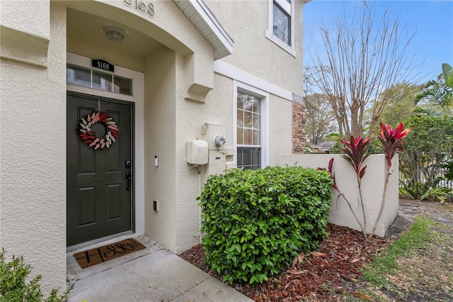 property entrance with stucco siding