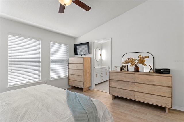 bedroom featuring light wood-type flooring, vaulted ceiling, and ceiling fan