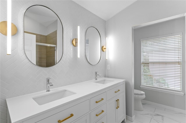 full bathroom with toilet, marble finish floor, a shower stall, and a sink