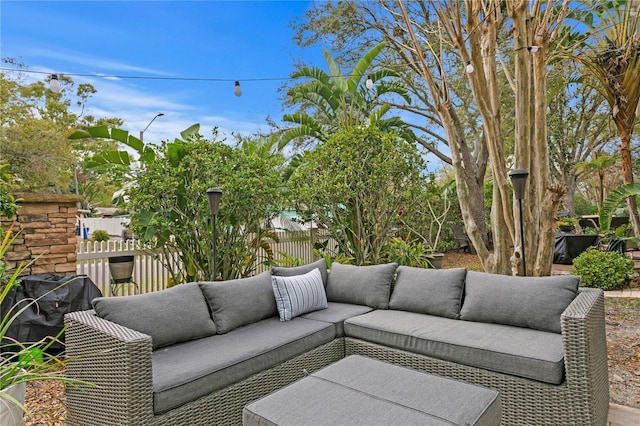 view of patio featuring fence and an outdoor hangout area