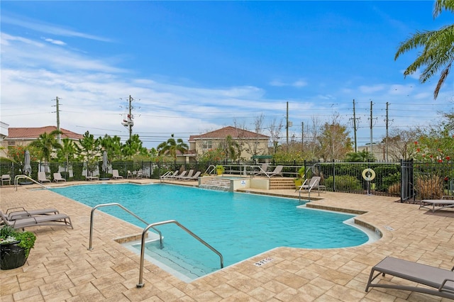 pool with fence and a patio