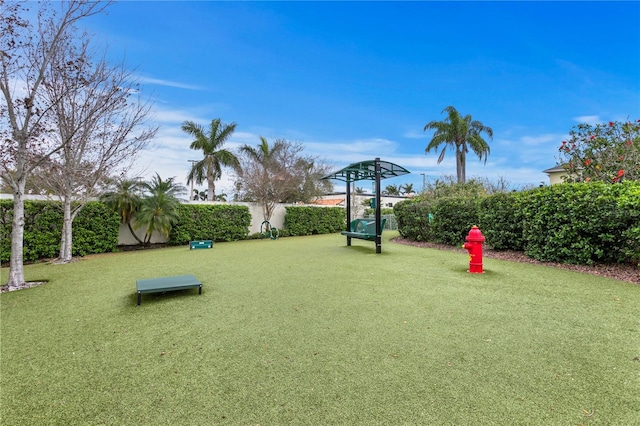 exterior space with a lawn and fence