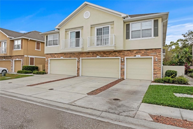 townhome / multi-family property with stone siding and stucco siding