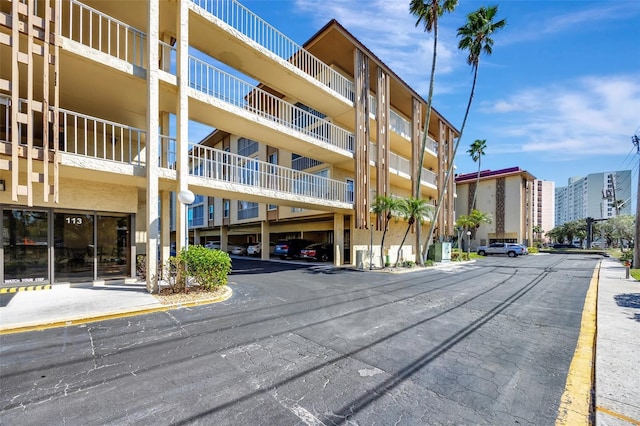 view of building exterior featuring covered parking