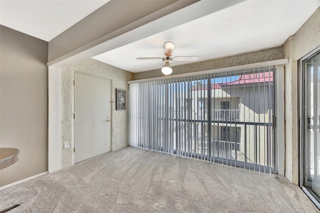 empty room with carpet and ceiling fan