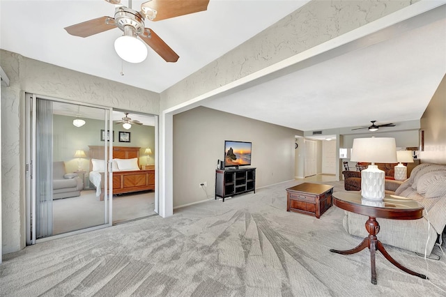 living room with ceiling fan, carpet flooring, and a textured wall