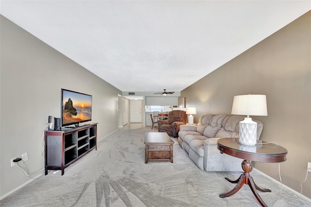 carpeted living room with baseboards, lofted ceiling, and a ceiling fan