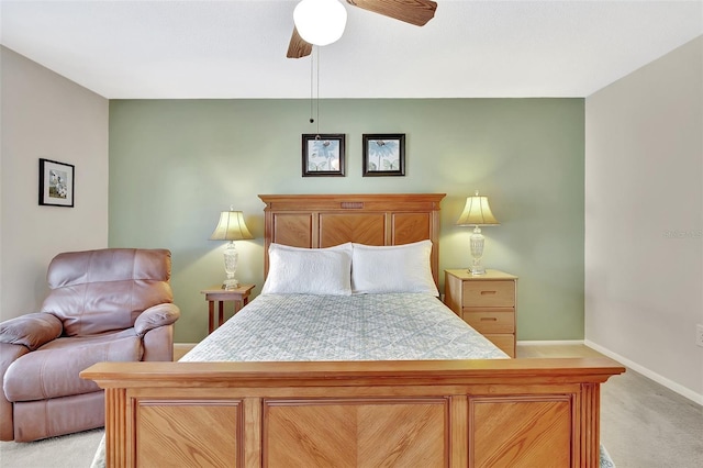 bedroom with light colored carpet, baseboards, and ceiling fan