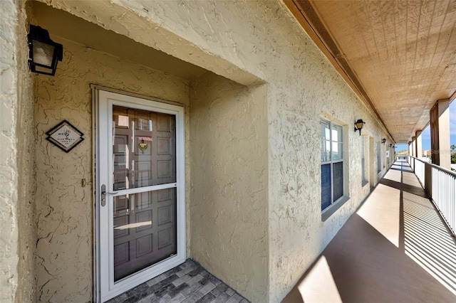 entrance to property featuring stucco siding